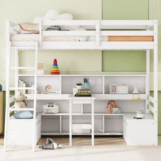 a white bunk bed sitting next to a desk in a child's playroom