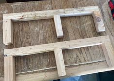 some wood pieces are laying on top of a table and ready to be glued together