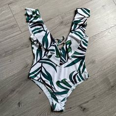 Nwot Zaful Leaf Print Ruffle Plunging Swimsuit In Size L. Give Yourself A Fun Summer Look With This Vibrant Leaf Print One-Piece Swimsuit. The Low Collarline And Low Back Are Decorated With Sweet Ruffles That Add A Little Chic To Your Sunny Days. Better Fit For Women With Smaller Breast. Never Worn. No Original Tags. Bra Style: Padded Support Type: Wire Free Collar-Line: Plunging Collar Pattern Type: Leaf Decoration: Ruffles White Summer One Piece With Ruffles, White Summer One-piece With Ruffles, White Ruffled One-piece Swimwear, White Ruffled One-piece For Summer, White Ruffled Summer One Piece, White Ruffled Summer One-piece, White Ruffled One-piece Swimsuit, White Ruffled One-piece For Beach Season, White Ruffled One Pieces For Summer