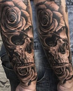 a man's arm with two skulls and roses on it