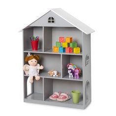 a toy doll house with toys on the shelves and in it's storage area