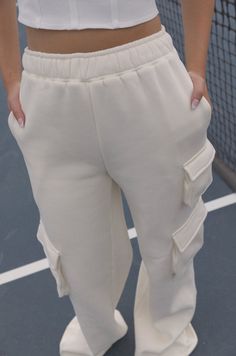 Stay comfortable in style with these Sporty Spice Cream Fleece Sweatpants. Made of butter-soft fleece fabric in a relaxed fit, these sweatpants are perfect for lounging or exercising. Delightful features include a high waist and two mini pockets on the sides. Move with confidence in comfy confidence and style. butter soft relaxed fit high waist mini side pockets cream 80% polyester 20% cotton model is wearing a small Cozy Fleece Sweatpants With Pockets, Comfy Joggers With Pockets For Leisure, Cozy Fit Comfy Sweatpants With Pockets, Cozy Fit Fleece Bottoms For Loungewear, Comfortable Fleece Bottoms For Loungewear, Cozy Fit Sweats With Pockets, Comfy Sweatpants With Side Pockets For Lounging, Fleece Bottoms With Comfort Waistband For Loungewear, Comfortable Joggers With Side Pockets For Loungewear