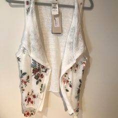 Embroidered White Vest, Draped Open Front, Sleeveless, Draped Over Lay With Floral Embroidery. Made In Italy. Sold Out At Nordstrom’s. Nwt With Small Stain Than Will Wash Out - See Photo. Pit To Pit: 24” Length: 27” Condition: Excellent Sleeveless Embroidered Spring Vest, Spring Embroidered Sleeveless Vest, Embroidered Sleeveless Vest For Spring, Spring Sleeveless Embroidered Vest, Sleeveless Embroidered Vest For Spring, White Embroidered Summer Vest, Sleeveless Floral Embroidered Top For Summer, Sleeveless Spring Embroidered Top With Floral Embroidery, White Embroidered Spring Vest