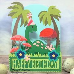 a birthday card with an image of a dinosaur in the grass and mushrooms on it