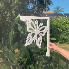 a person holding up a cutout of a butterfly