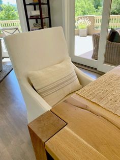 a white chair sitting next to a wooden table