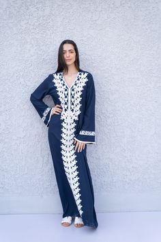 "A stunning embroidered Kaftan dress that is elegant, colorful, and unique! The dress is made of Egyptian cotton that has a soft feel to it so you will surely feel comfortable and royal in it. It also comes with a small invisible pocket on the right side of the Kaftan for added practicality. You can wear this Kaftan practically anywhere and for any occasion. You can dress it up with a pair of heels and strut like an Egyptian queen in any gathering, resort, or party. Or you can dress it down with Floral Embroidered Floor-length Kaftan For Eid, Bohemian Long Sleeve Tunic With Intricate Embroidery, V-neck Dress With Intricate Embroidery For Eid, Embroidered Blue Long Sleeve Abaya, Eid Maxi Dress With Intricate Embroidery, Bohemian Long Sleeve Kaftan With Intricate Embroidery, Traditional Long Sleeve Maxi Dress With Multicolor Embroidery, Long Sleeve Blue Abaya With Floral Embroidery, Festive Long Sleeve Thobe With Floral Embroidery