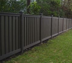 a fence in the middle of a grassy area