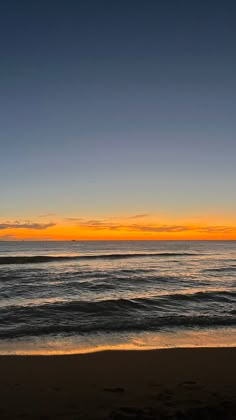 an orange and blue sunset over the ocean