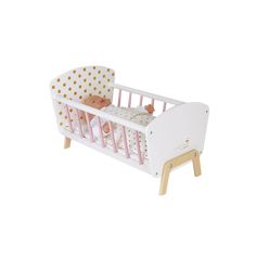 a white crib with a pink and gold polka dot cover on the bedding