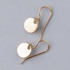 These sleek and modern Tiny Disc Dangle Earrings are the perfect accessory for any outfit. Made with 14k goldfill, they are both beautiful and durable. The smooth discs catch the light beautifully, making them the perfect earrings for a night out or a special occasion. Whether you're dressing up or dressing down, these earrings will add a touch of elegance to your look. Gold Round Threader Earrings For Everyday, Adjustable Modern Earrings In 14k Gold Filled, Modern Adjustable 14k Gold Filled Earrings, Adjustable Minimalist Yellow Gold Earrings, Simple Design 14k Gold Earrings, Minimalist Round Linear Earrings For Everyday, Minimalist Nickel-free Yellow Gold Linear Earrings, Minimalist Yellow Gold Linear Earrings Nickel Free, Gold Round Disc Earrings For Everyday