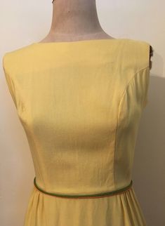 "Bright and beautiful yellow embroidered sleeveless dress from the 1960's is a figure hugging spring essential! Dress is made from a lightweight cotton/rayon and zips up the back with hook and eyes at the waistline and the back of the neck. Dress is in excellent vintage condition. Shoulders 14\" Chest 38\" Waist 25\" Hips 38\" Length from top of shoulder to hem 40\" Armhole 8\" Vintage garments have been previously worn and lovingly cared for, they may however have a blemish or two. Here at Made Fitted Yellow Cotton Dress, Retro Yellow Cotton Dress, Fitted Mustard Cotton Dress, Mustard Fitted Cotton Dress, Fitted Vintage Mustard Dress, Fitted Mustard Dress For Daywear, Yellow Sundress Outfit, Vintage 1960s Dresses, Vintage Blouse Pattern