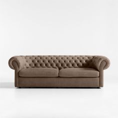 a brown couch sitting on top of a white floor