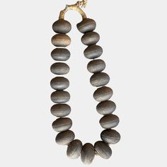 a necklace made out of rocks on a white background