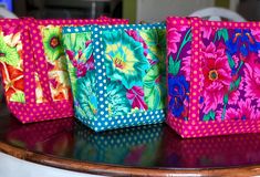 three brightly colored bags sitting on top of a table