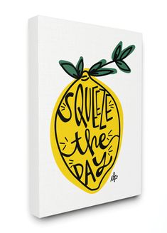 a canvas with the words squeeze the day written in black on it, and a yellow lemon