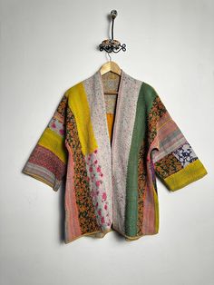 a colorful jacket hanging on a white wall