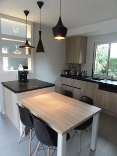 a kitchen with an island table and chairs in the center, next to a window