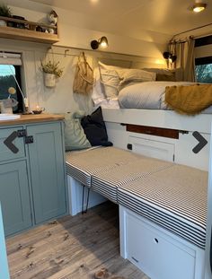 the interior of a camper with bunk beds and storage space on each side is shown