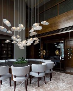 an elegant dining room with chandelier and chairs in the middle of the room