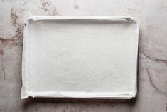 an empty white tray on a marble surface