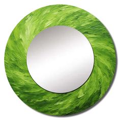 a round mirror with green grass on it's side and a white circle in the middle