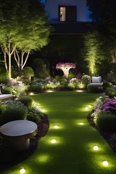 an outdoor garden at night with lights on the grass