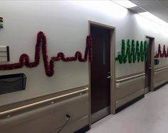 an empty hospital hallway decorated with red, green and white streamers that spell out the word hope