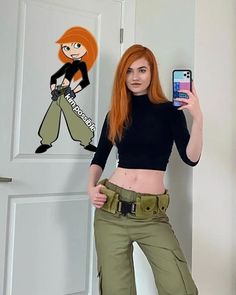 a woman with red hair is holding up her cell phone and posing for the camera