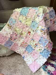 a baby quilt is laying on the floor