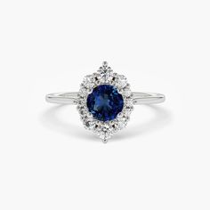 a blue sapphire and diamond ring on a white background