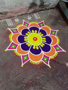 a colorful flower design painted on the ground