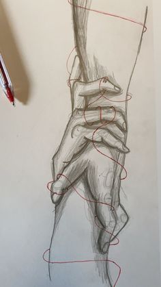 a pencil drawing of a person's hand holding something with red lines on it