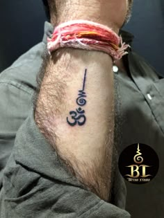 a man with a tattoo on his arm that says om shantiya in black ink