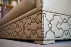 a close up view of the side of a bed with beading on it's sides