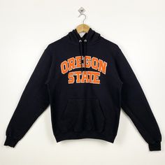 Vintage NCAA Oregon State University 'Beavers' Hoodie Embroidery Black Color Men's S - Made in Nicaragua - Materials : Cotton, Polyester  - Tag Reads : S Kindly see the actual measurements (All measurements were taken lying flat) - Actual size manual measurements * Width (Armpit to armpit) : 20 inches * Length (Shoulder to end of garment) : 24 inches * Sleeve length : 26.5 inches - Condition : * Vintage condition 9/10 (90%) * Free from stain, tear and major defect - Shipping : * DHL Express/FedE Sports Season Hoodie With Embroidered Logo, College Sports Season Sweatshirt With Double-lined Hood, College Sweatshirt For Sports Season With Double-lined Hood, Collegiate Sweatshirt With Double-lined Hood, College Fleece Sweatshirt With Double-lined Hood, Collegiate Hooded Sweatshirt For College, Sporty Hoodie With Embroidered Graphics For Winter, Collegiate Cotton Hoodie With Embroidered Logo, Black Collegiate Sweatshirt With Embroidered Logo