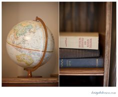 a globe sitting on top of a wooden shelf next to books