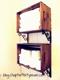 two wooden shelves holding toilet paper and napkins