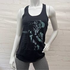 a female mannequin wearing a black tank top with an image of a woman on it