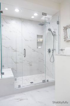 a bathroom with a walk in shower next to a sink