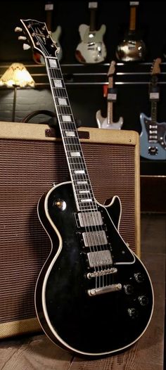 an electric guitar sitting on top of a wooden table