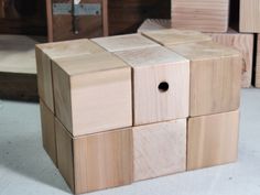 several wooden blocks stacked on top of each other with holes in the middle to make them look like cubes