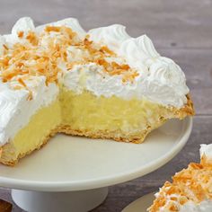 a piece of coconut cream pie on a white plate with one slice missing from it