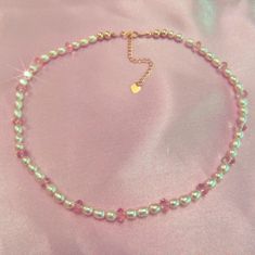 A one of a kind handmade piece (literally only one made elegant and fun: This rice pearl choker is adorned with baby pink Swarovski crystals for every three sets of fresh water pearls throughout the entire choker. The end pieces are finished off by two gold filled beads and 14K gold filled closures.  This pearl choker will stand out all on its own, but have fun and layer it up with more beaded necklaces! Or pair with some gold dainty jewels. You will feel the quality while wearing this beautiful choker. Pink Pearl Beaded Necklace With Pearl Charm, Handmade Pink Pearl Beaded Necklaces, Pink Beaded Necklaces With Pearl Charm, Pink Pearl Beaded Necklace Gift, Pink Pearl Necklace With Colorful Beads As A Gift, Pink Pearl Beaded Necklace For Gift, Dainty Pink Pearl Beaded Necklaces, Delicate Pink Pearl Necklace, Pink Pearl Chain Beaded Necklaces With Round Beads