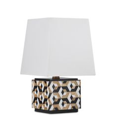 a table lamp with a white shade on it's base and an abstract design