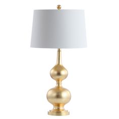 a gold table lamp with a white shade