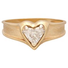 Love is in the air! With this 14k gold engagement ring, express your love with a heart-shaped diamond weighing approximately .58-ct., and graded G-H color and VS-SI. Set in a polished heart frame with a tapering satin band, the ring harks back to the 1950's era of love and optimism. The ring weighs 3.1 grams, and is currently size 8, with easy up/down adjustment. A ring of pure romance! Antique Sapphire Engagement Rings, Vintage Sapphire Engagement Rings, Heart Cut Diamond Ring, Heart Shaped Diamond Ring, Heart Shaped Engagement Rings, Easy Up, Sapphire Engagement Rings, Heart Engagement Rings, Diamond Heart Ring