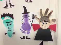 handprinted puppets are hanging on the door for kids to use in halloween costumes