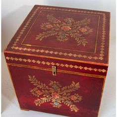 an ornately decorated red box with gold trimmings