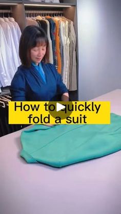 a woman standing in front of a clothing rack